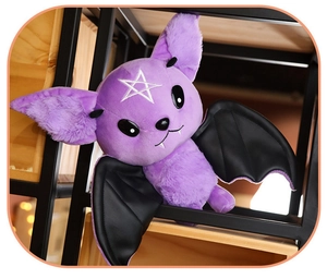 Detail of purple gothic bat plush toy featuring black PU leather wings and star embroidery
