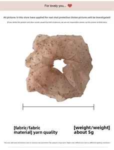 Detail of light pink mesh scrunchie with soft flocked polka dots and sheer fabric texture