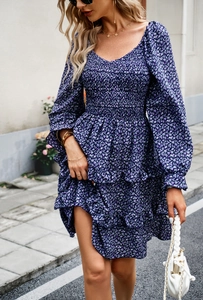 Detail of floral V-neck dress with lantern sleeves and layered tiered skirt style