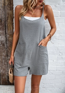 Close-up of casual grey strapless jumpsuit with side pockets and layered white top