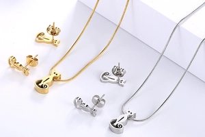 Detailed view of cute cat necklace and earrings set in gold and silver finishes