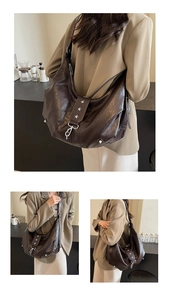 Macro detail of dark brown hobo bag featuring vintage texture and silver star rivets