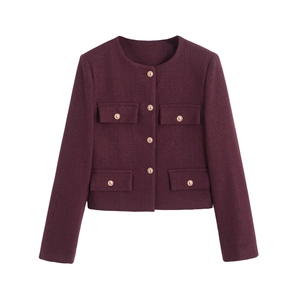 Detailed view of burgundy tweed jacket featuring golden metal buttons and woven texture