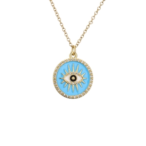 Gold Evil Eye necklace with blue enamel and pave set cubic zirconia stones on white background