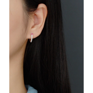 Close-up of S925 silver hoop earring with pink and white zirconia stones on ear
