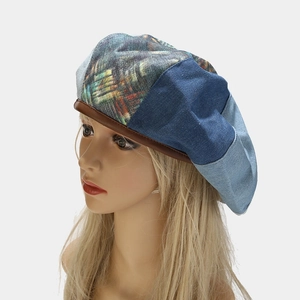 Detail of vintage patchwork beret with denim blocks and brown leather piping trim