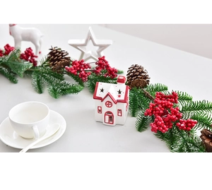 Detailed view of Christmas garland with red berries, pine cones and green needles