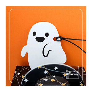 Close-up of a cute cartoon ghost gift tag with black string on a vibrant orange background