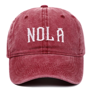 Front view of deep red washed cotton baseball cap with white NOLA embroidery detail