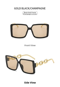 Detail view of large square black and gold frame sunglasses with champagne lenses