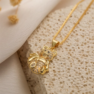 Macro shot of 18k gold plated bear pendant necklace with sparkling zircon pavé