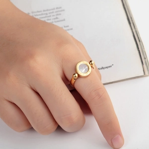 Chic titanium steel gold ring with Roman numerals and white shell on model hand