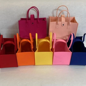 Set of seven colorful felt tote bags with handles and snap buttons for gifts and storage