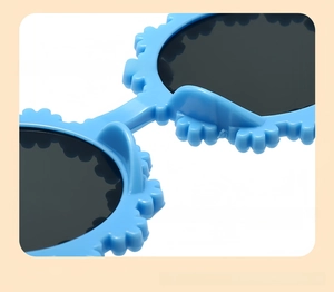 Detailed close-up of sky blue daisy flower sunglasses with petal edge and dark lenses