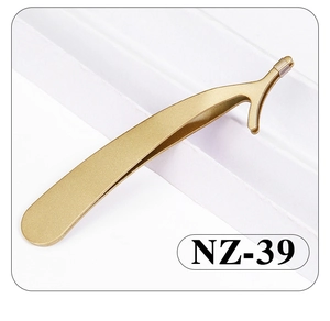 Detailed macro view of golden stainless steel eyelash applicator tweezers model NZ-39