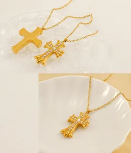 Detail view of gold-plated stainless steel cross pendants with white zircon stones