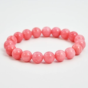 Detailed view of pink natural stone beads with smooth texture and soft rosy glow