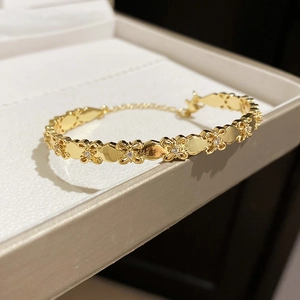 Detail view of 18k gold plated iris flower bracelet with sparkling cubic zirconia accents