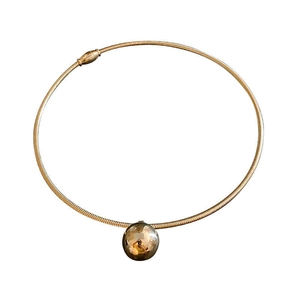 Minimalist gold metal collar necklace with a large polished spherical pendant for women