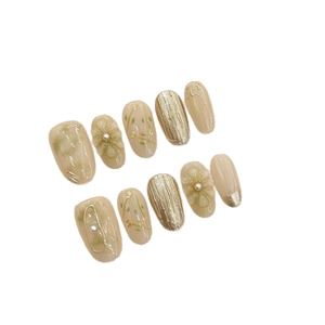 Handmade press-on nails with 3D floral relief pearls and gold foil in nude tones