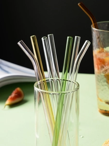 Close-up of colorful heat-resistant borosilicate glass straws in straight and curved shapes
