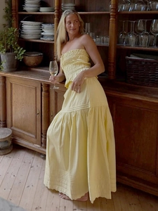 Two-piece light yellow strapless crop top and maxi A-line skirt set for vacation style