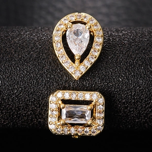 Macro shot of gold-plated ring with pear and rectangular shaped zircon gemstones