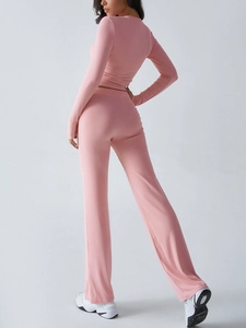 Rear view of pink long sleeve yoga top and leggings set in soft stretch fabric