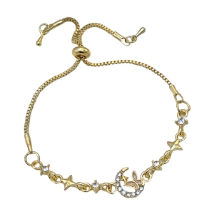 Detail of adjustable gold bracelet with crystal moon star and butterfly pendants