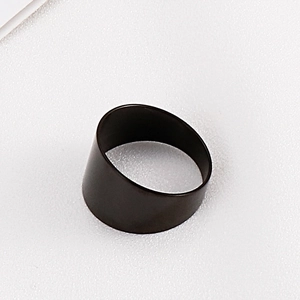Detail of minimalist wide black matte titanium steel ring with smooth metal finish