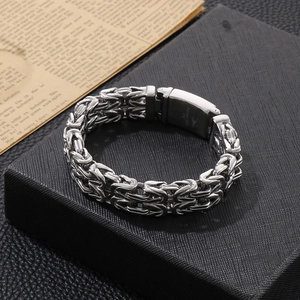 Close-up of rock hip hop style Byzantine stainless steel bracelet on leather box
