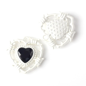 Macro view of silver thorn heart pendants with black zircon for DIY jewelry making