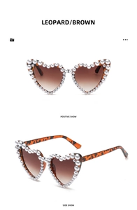 Detail of heart-shaped leopard sunglasses with embedded white pearls and brown lenses