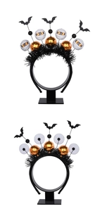 Detail of Halloween headband featuring bats, mummy eyes, and orange glitter balls