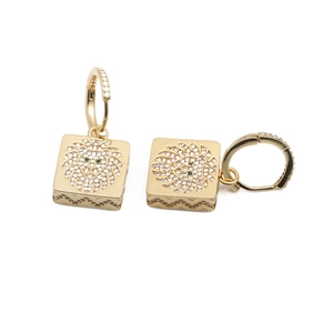 Detail of square lion head drop earrings with gold plating and cubic zirconia inlay