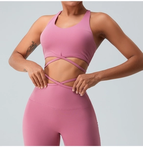 Detail of pink sports bra with cross-strap waist design and high-elastic yoga fabric