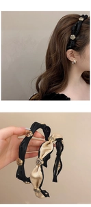 Detail of satin headbands with golden metal roses and rhinestones in black and champagne