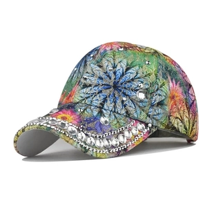 Macro detail of vibrant floral print and sparkling white rhinestones on stylish baseball cap
