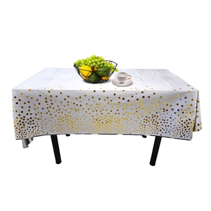 Close-up of a white rectangular tablecloth with gold polka dots and fruit basket set