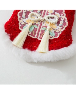 Detail of red fleece festive pet vest with white fur collar and pearl tassel knot