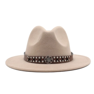 Close-up of wool fedora hat with double-row metal studs and ethnic engraved buckle detail
