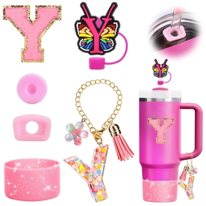 Detail view of pink glitter letter Y charm and resin butterfly straw topper accessories