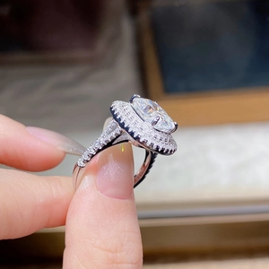 Detailed close-up of S925 silver halo ring with large oval moissanite and micro-pave diamonds