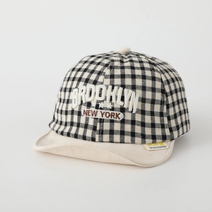 Detail of Brooklyn embroidery on black and white gingham baby sun hat with flat peak