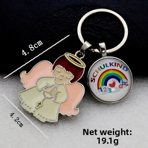 Detail of Schulkind metal keychain with angel charm and rainbow pendant showing dimensions