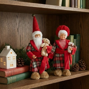 Standing Santa and Mrs. Claus figurines in red plaid robes for Christmas decor