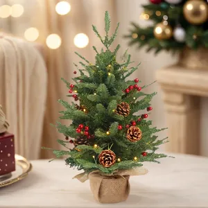 Mini artificial Christmas tree with pine cones red berries and LED lights in burlap base