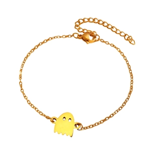 Detail of gold hollow-eye ghost pendant on a polished stainless steel chain bracelet