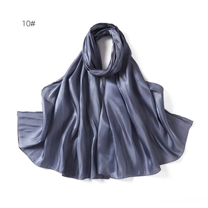 Detail showing smooth grey-blue satin fabric texture with glossy finish and fine edges