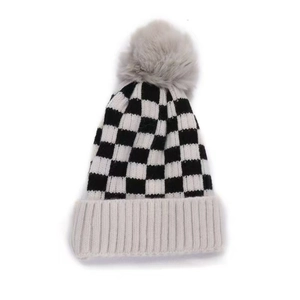 Winter checkered knit beanie with warm fleece pom-pom and ribbed edge for outdoor warmth